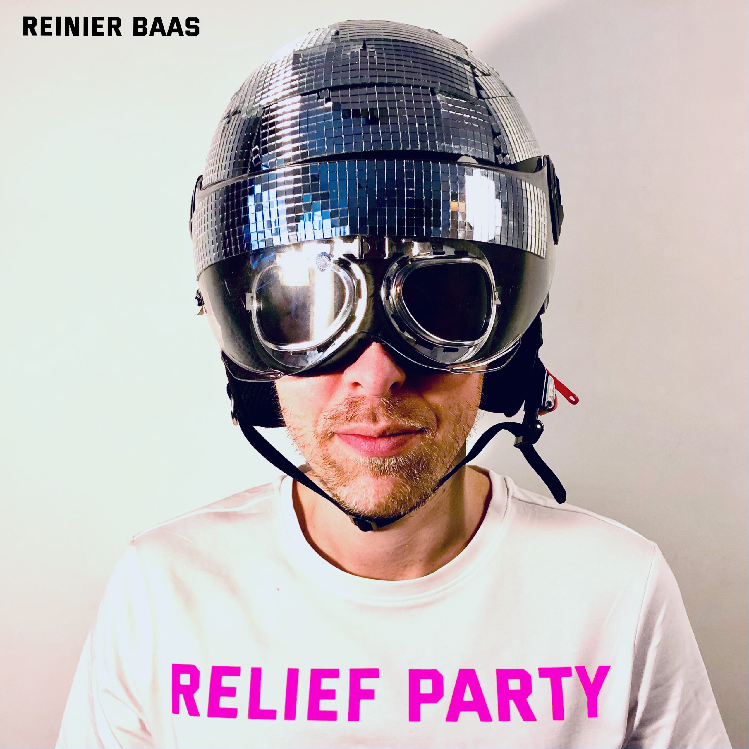 Album cover featuring Reinier Baas with a reflective disco ball helmet and aviator goggles, titled 'RELIEF PARTY' in pink capital letters on a white T-shirt